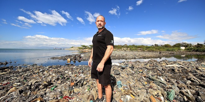 Plastic Bank Founder David Katz surrounded by ocean plastic