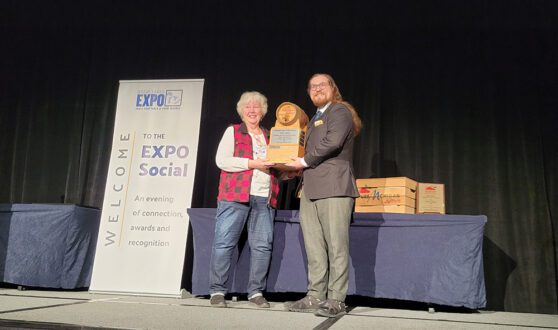 Mary Cooper of Farmer White’s of Williamsburg, Michigan, won first place at the Michigan Apple Cider Contest. Michigan State University’s Derek Plotkowski presented the award. Photos by Madi Schafer.