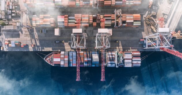 Top view of a cargo ship with containers in a port.