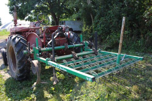 Weeder cultivator equipment on tractor.