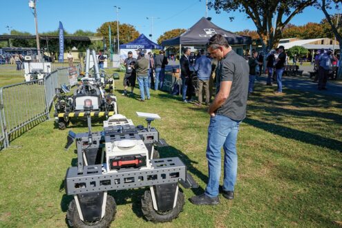 Man examining robotic ag equipment.