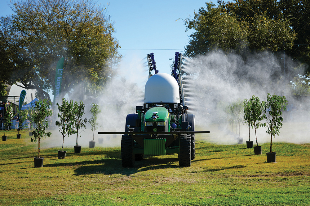 Robotic ag equipment spraying trees.