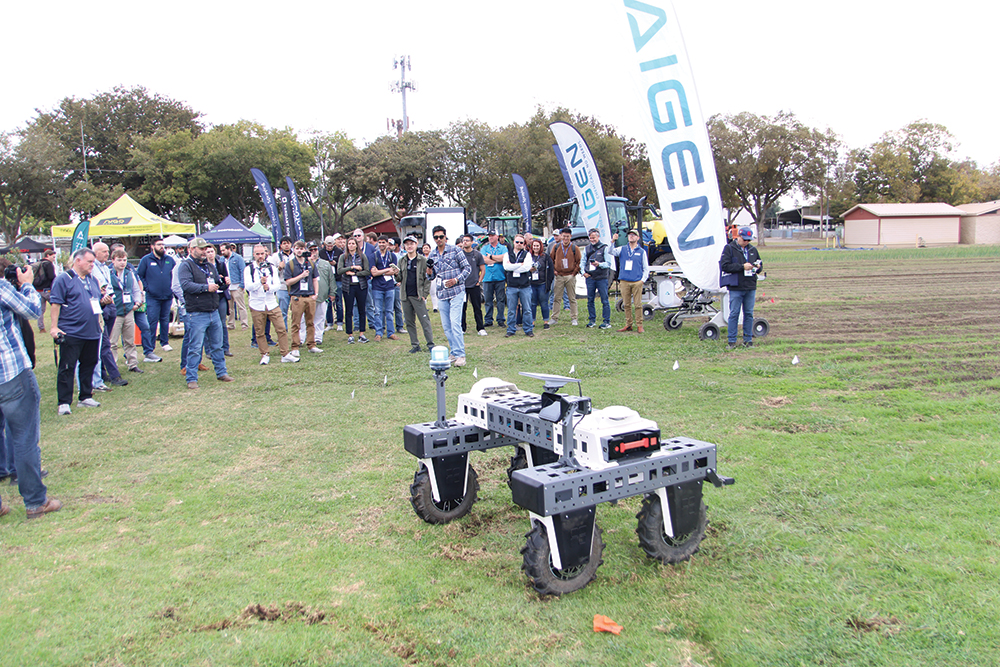 Farmers looking at robotic ag equipment.