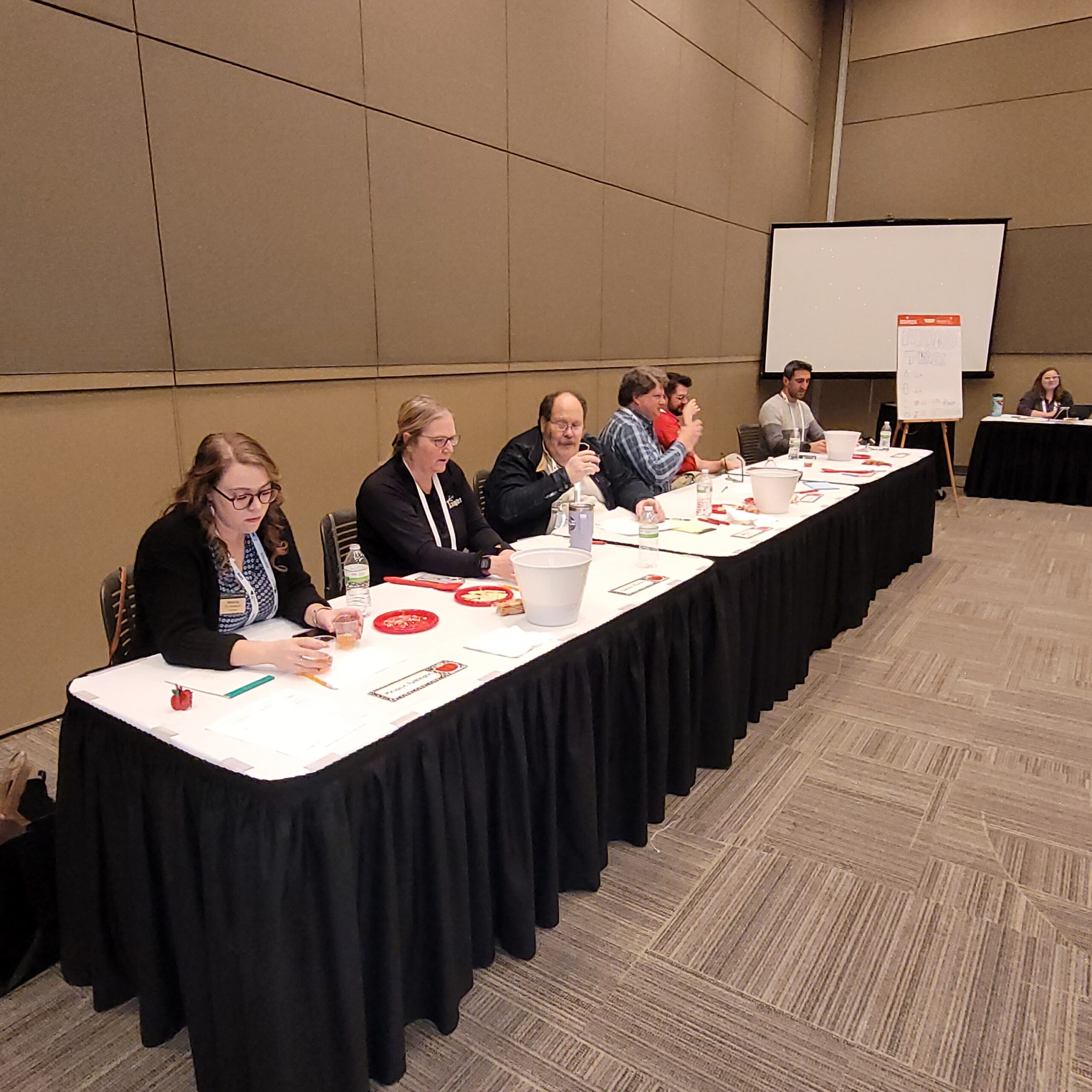 Photo of panel of judges grading cider entries at the 2024 GLEXPO cider contest. .