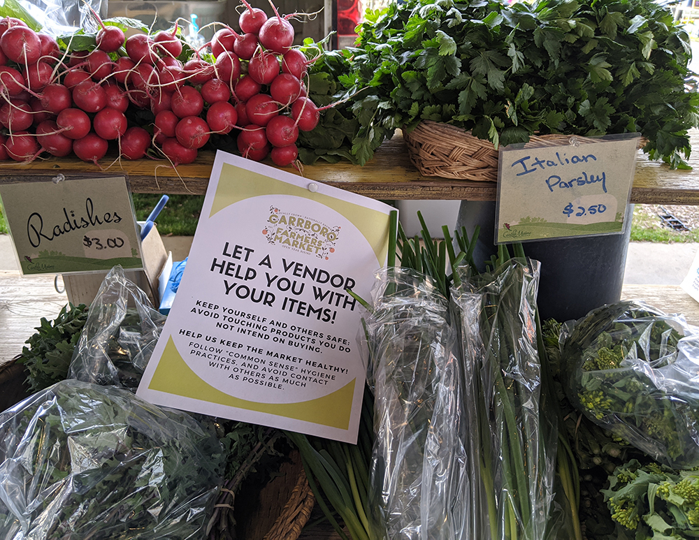 The market provided signs to vendors explaining the policy about customers NOT touching product.