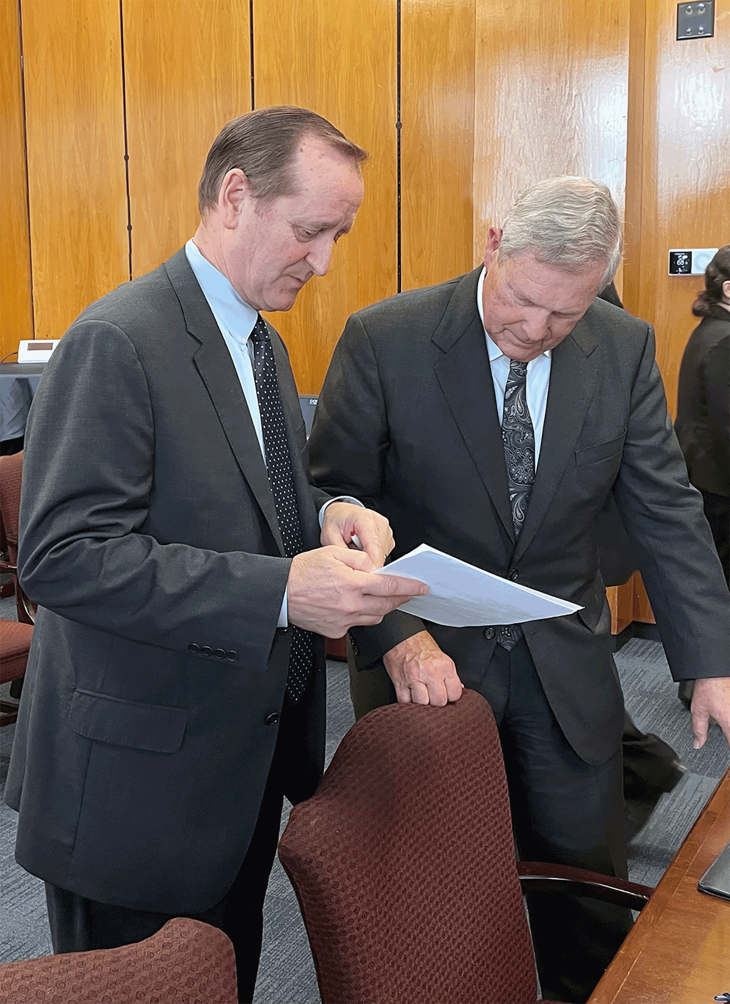 Jim Bair with Secretary of Agriculture Tom Vilsack. Jim is showing an economic analysis of apple production costs.