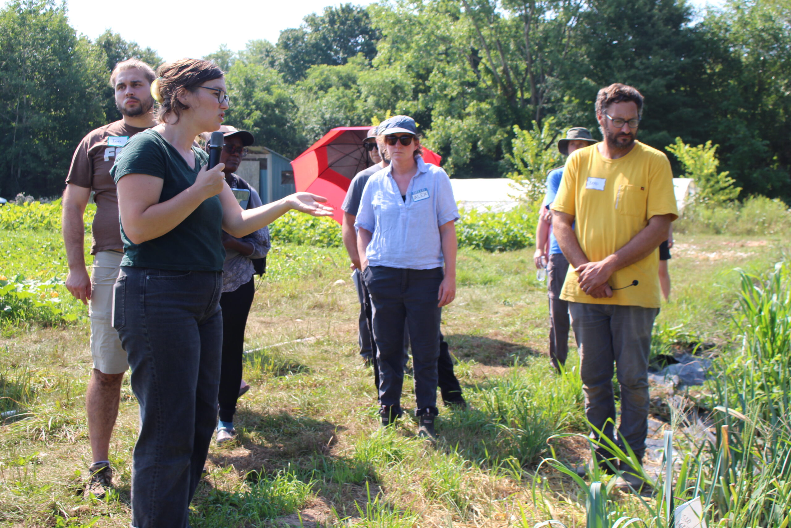 Man and woman addressing participants in field.