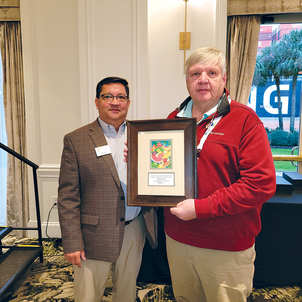 Chris Butts, left, and Andy Harrison, right. Andy is holding a framed award