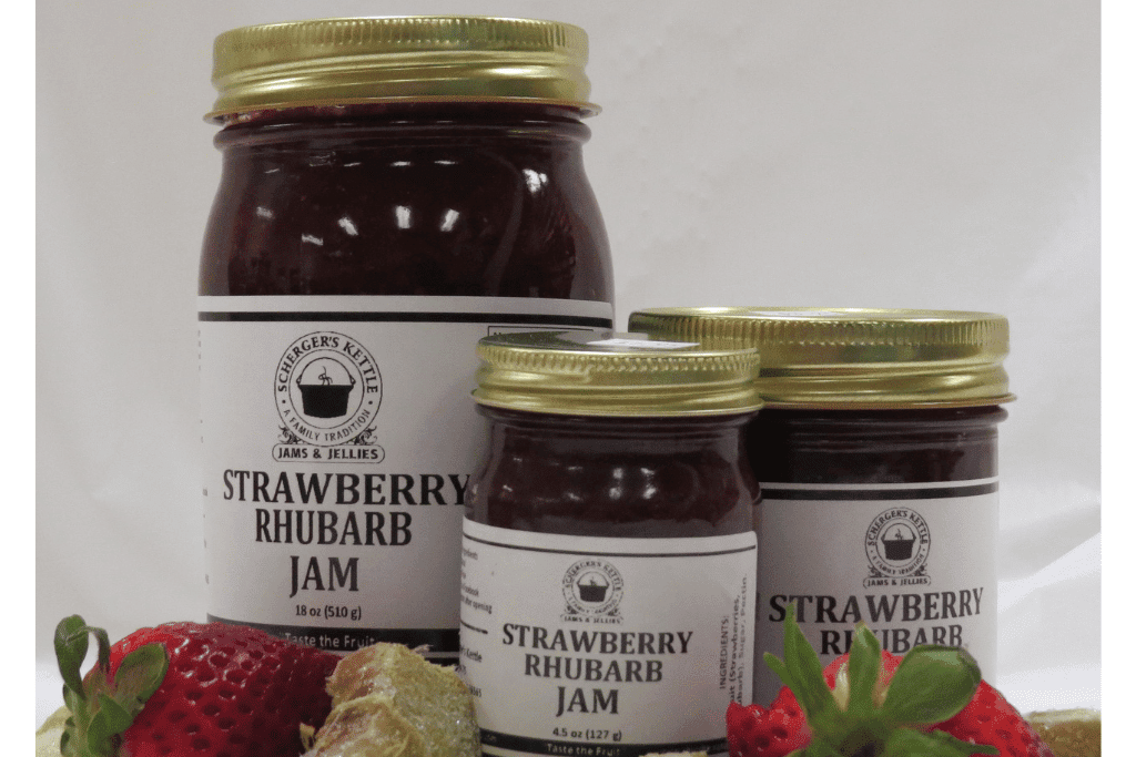 An image of three jars of strawberry rhubarb jam of different sizes